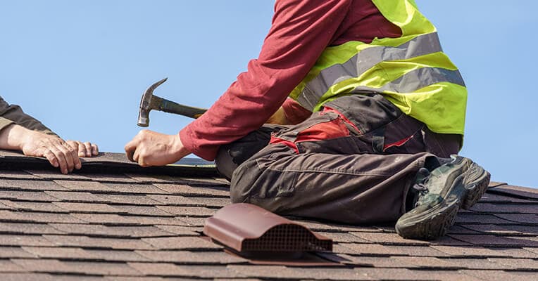 Professional roof repair on pitched roof